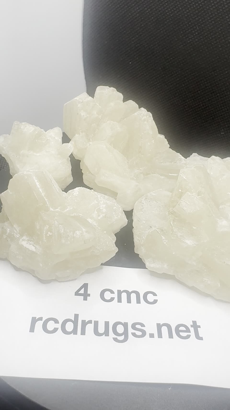 4-CMC crystals with a batch card.